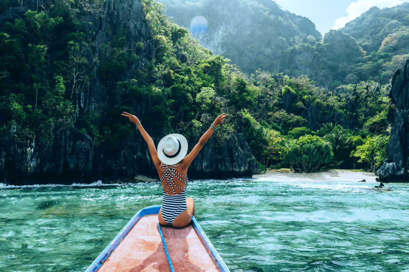 Kayaker paddling through the emerald water of El Nido's Big Lagoon, framed by towering limestone cliffs in Palawan.