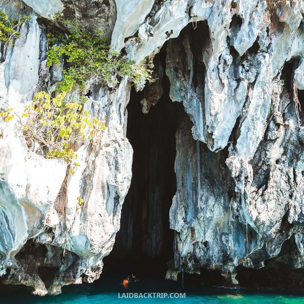 Towering limestone cave formations viewed from a tour boat, El Nido