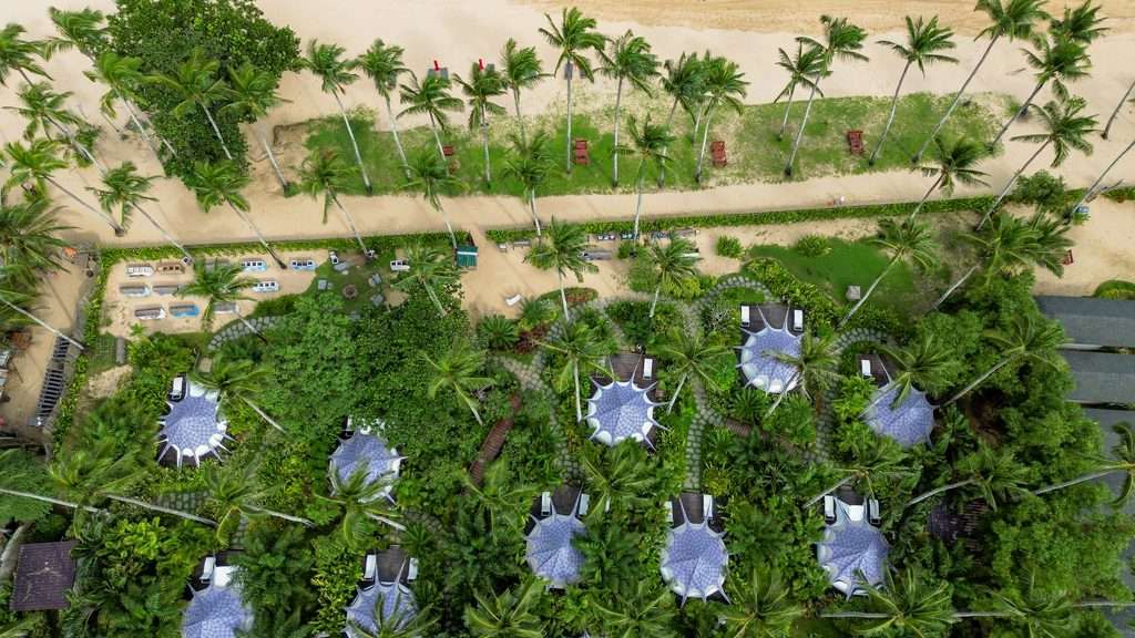 Aerial view of glamping tents beside the sand at Nacpan Beach, El Nido, Palawan