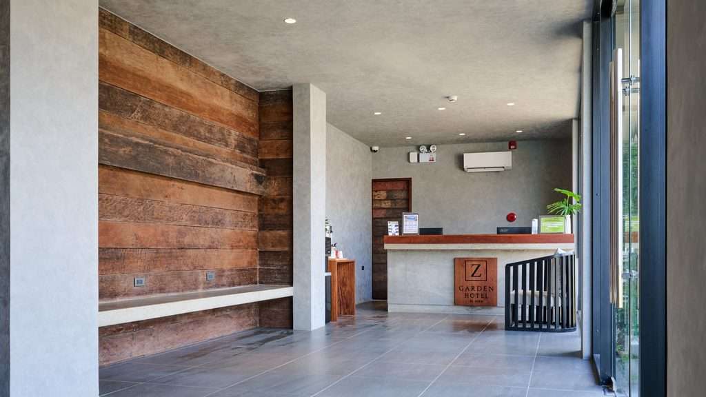 Reception and lobby at Z Garden Hotel El Nido with a reclaimed timber wall and polished concrete